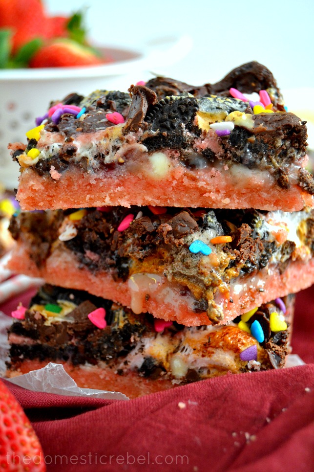 Neapolitan Seven Layer Bars stacked up close on red background