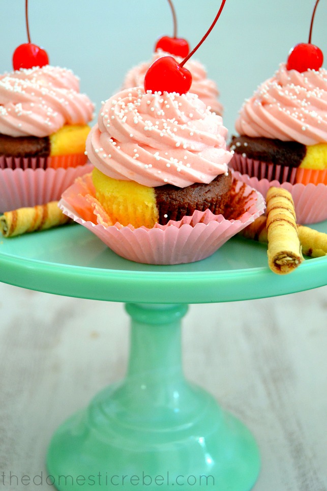 Neapolitan Cupcakes arranged on green cake stand with cookies on light background