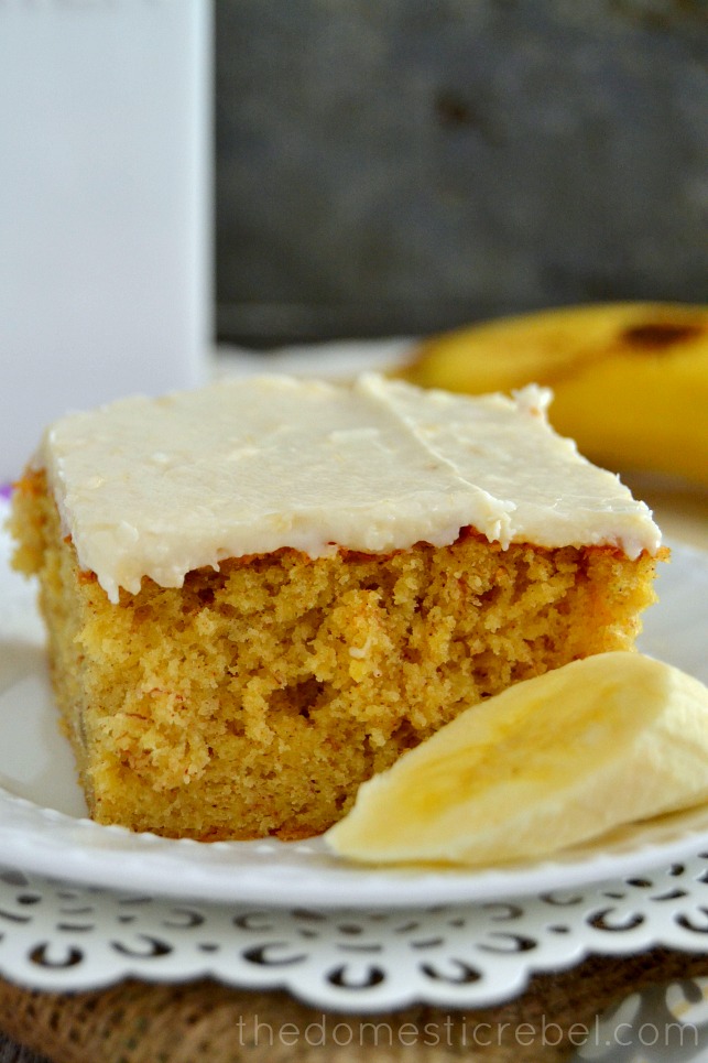 Best Banana Cake with Banana Frosting close up on white plate with metal background