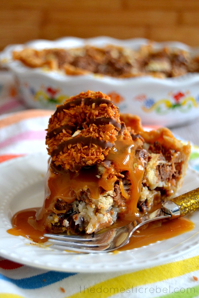 Samoas Magic Bar Pie on plate with fork and with bite removed