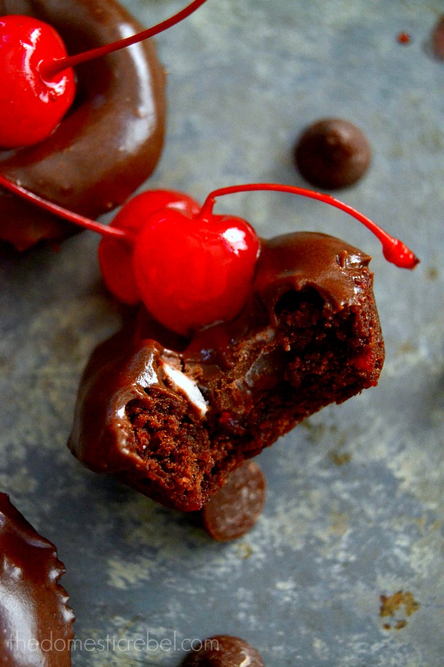 Chocolate Cherry Cookie Bites with bite removed on metal baking sheet with chocolate chips