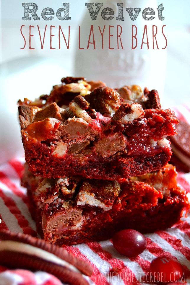 Red Velvet Seven Layer Bars stacked on a red and white background with candies
