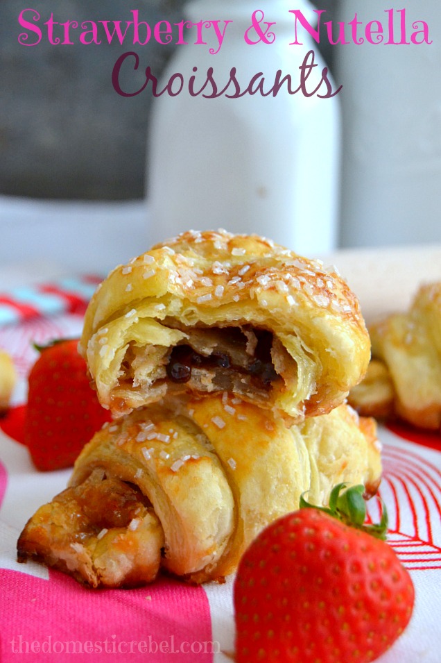 Strawberry & Nutella Croissants stacked on light pink background with strawberries