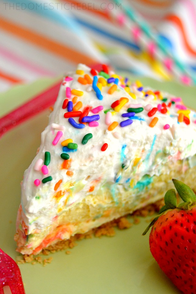 Funfetti Cream Pie slice on green plate with strawberry