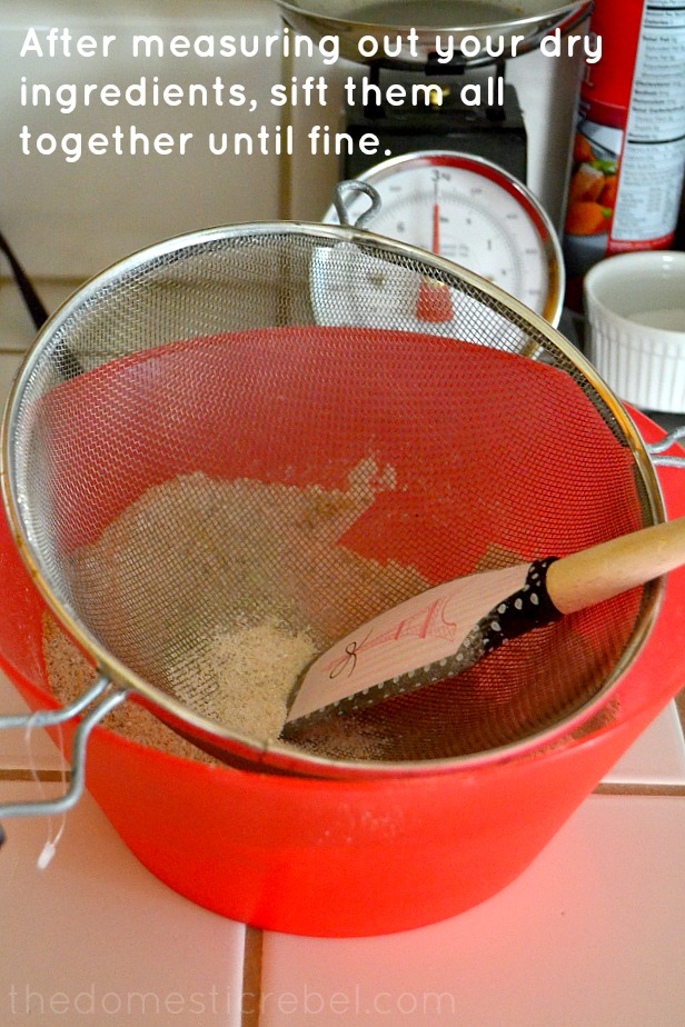 sifting dry ingredients for macarons into red bowl