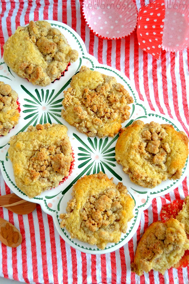 coffee cake crumble muffins arranged in muffin tin on red and white fabric