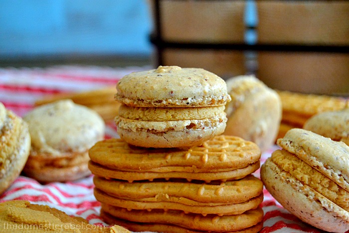 a nutter butter macaron sitting on stacked nutter butter cookies
