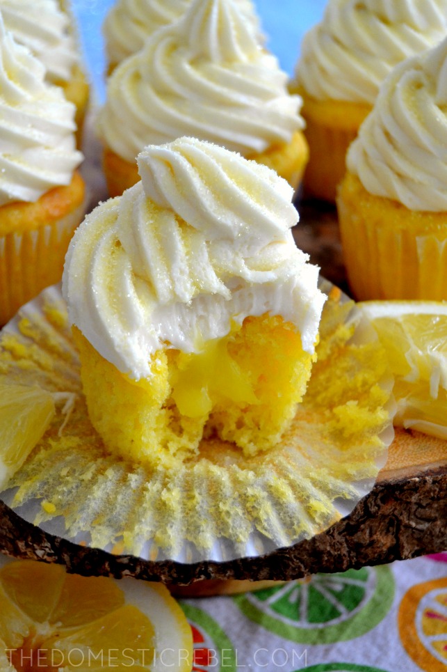 lemon bar cupcake with bite missing on wooden board