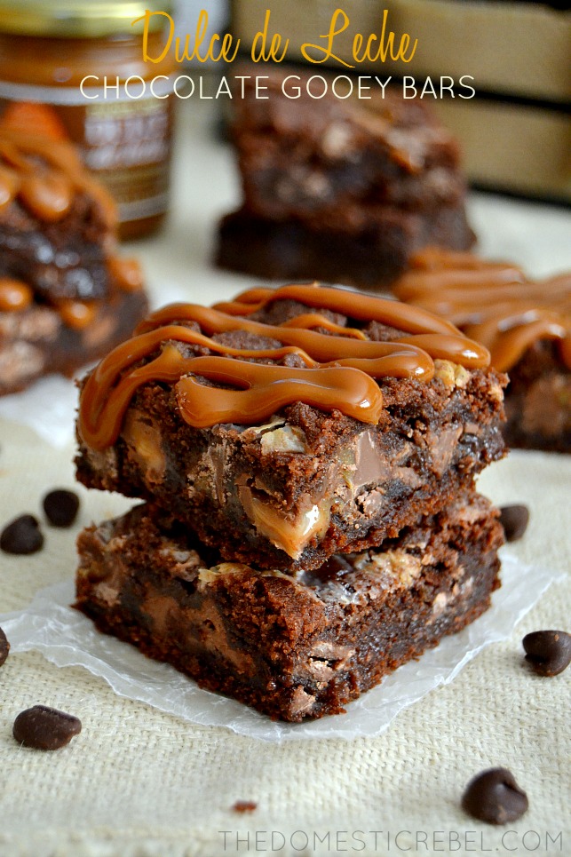 Dulce de Leche Chocolate Gooey Bars stacked on light background with chocolate chips