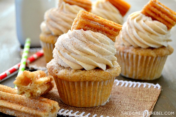 Churro Cupcakes arranged on burlap and wood with churro pieces