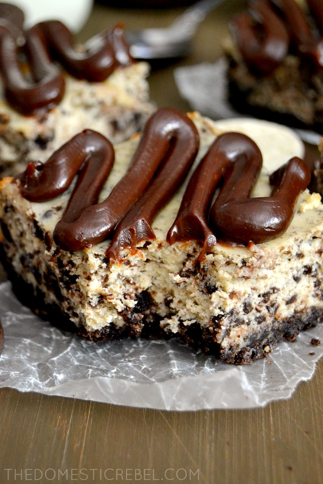 closeup of oreo cheesecake bar with bite removed on wood background