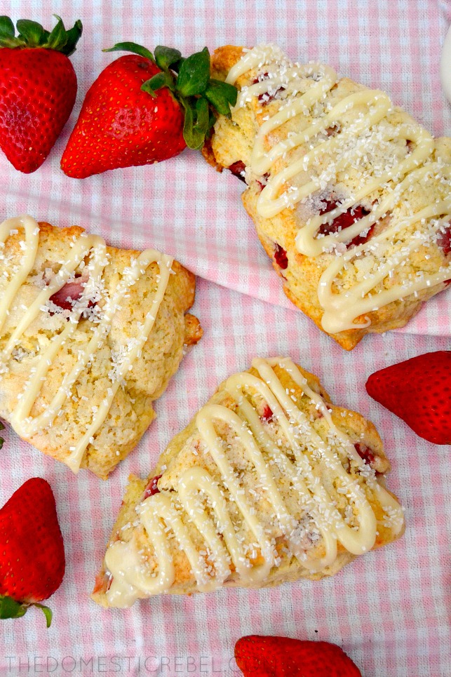 strawberry and cream scones arranged on pink gingham fabric with strawberries