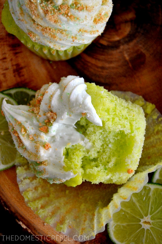 key lime pie cupcakes with bite removed on wood