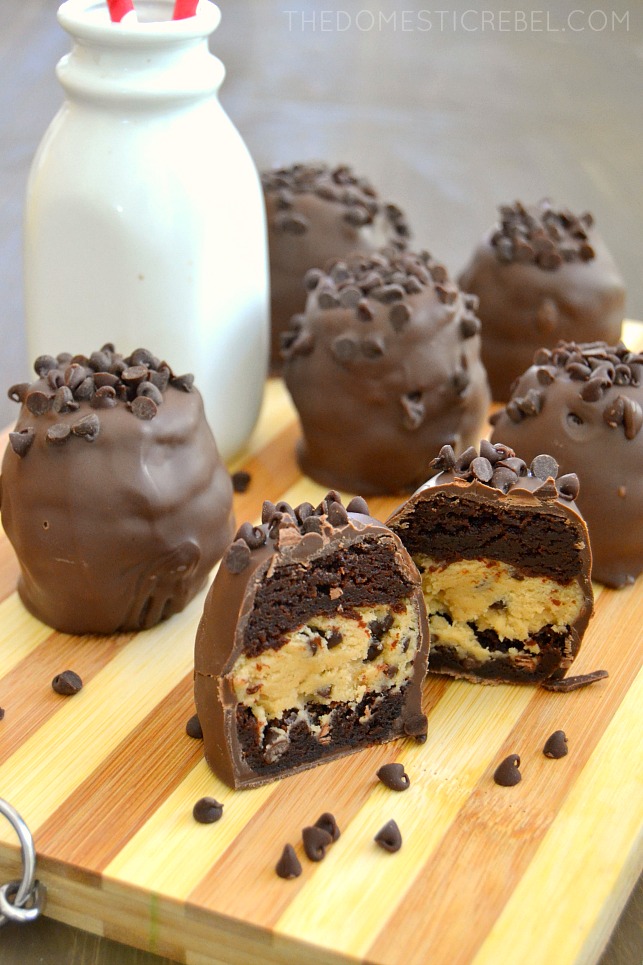 No Bake Cookie Dough Brownie Bombs arranged on wood with milk bottle