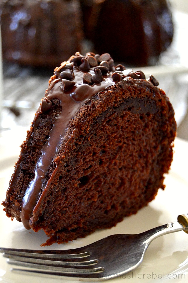 Slice of chocolate Bundt cake on white plate with fork