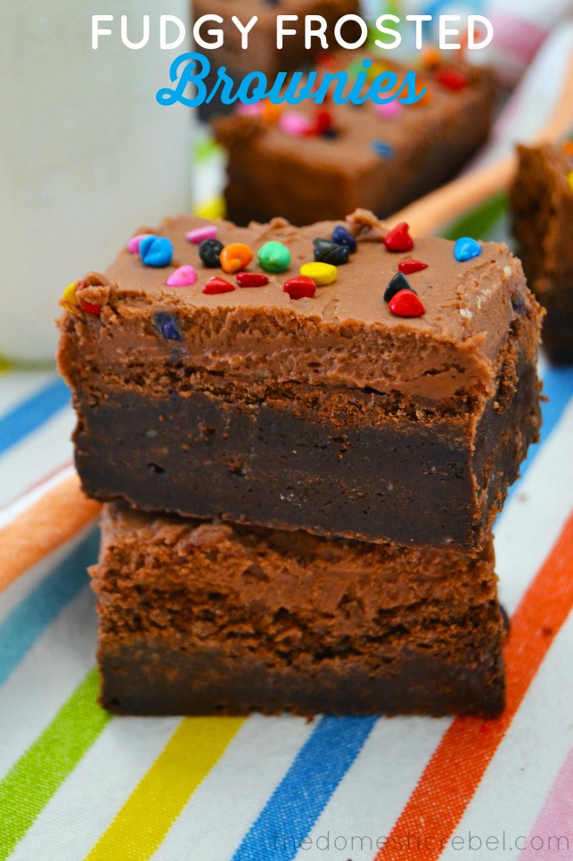 Fudgy Frosted Brownies stacked on rainbow fabric