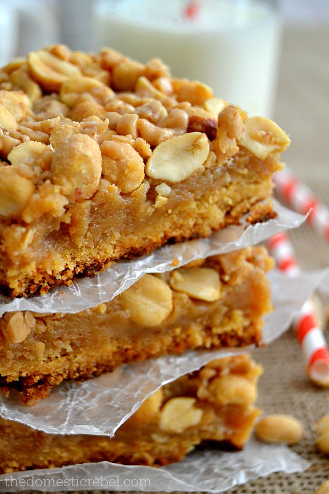 Closeup of Peanut Brittle Bars stacked between parchment squares