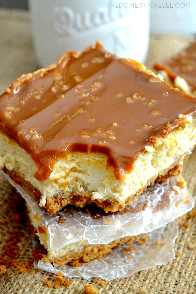 dulce de leche cheesecake bar stacked with bite missing on burlap