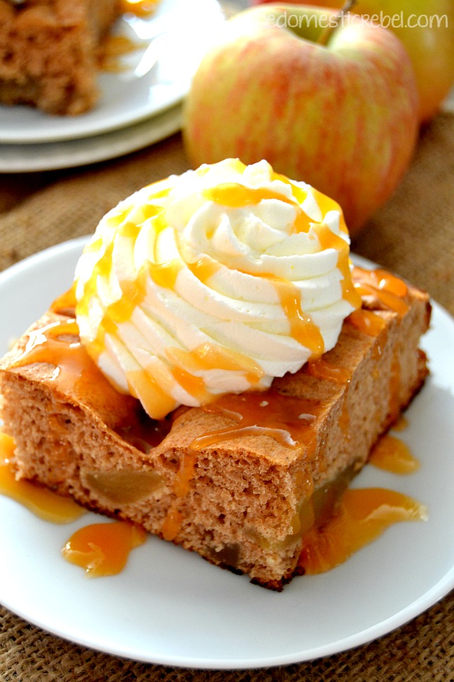 caramel apple spice cake on white plate with apple in background