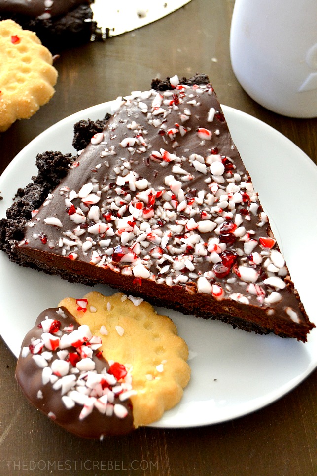 peppermint chocolate ganache pie slice on white plate with cookies