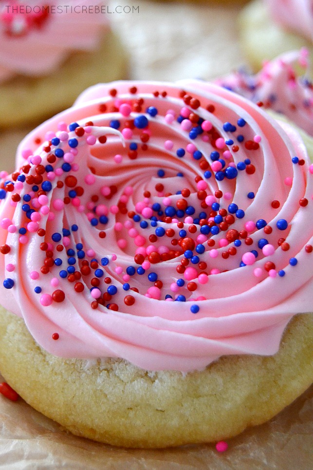 Closeup of a frosted almond sugar cookie with sprinkles