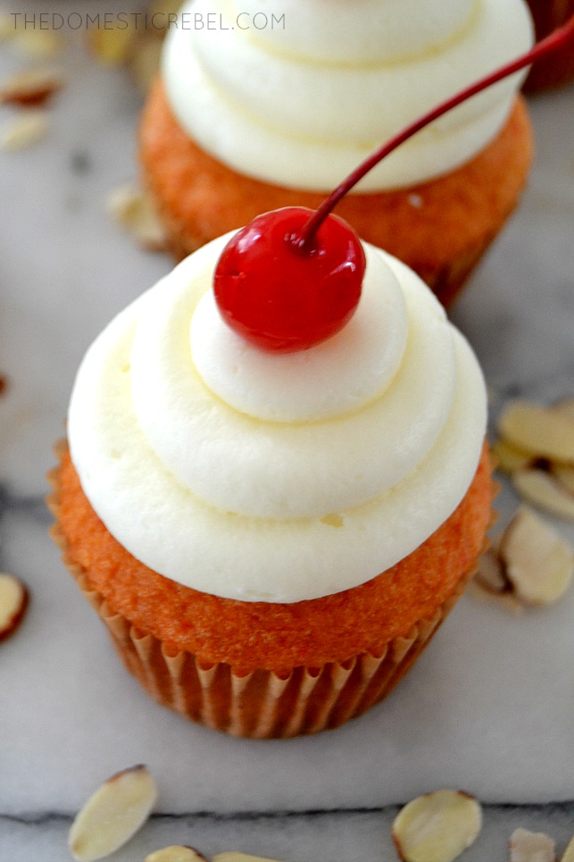 Closeup of Cherry Almond Cupcake on marble with scattered almonds