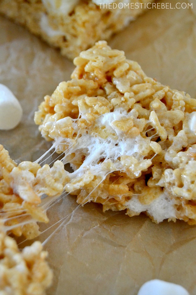 Rice Krispy Treat pulled apart to show gooey marshmallows on parchment