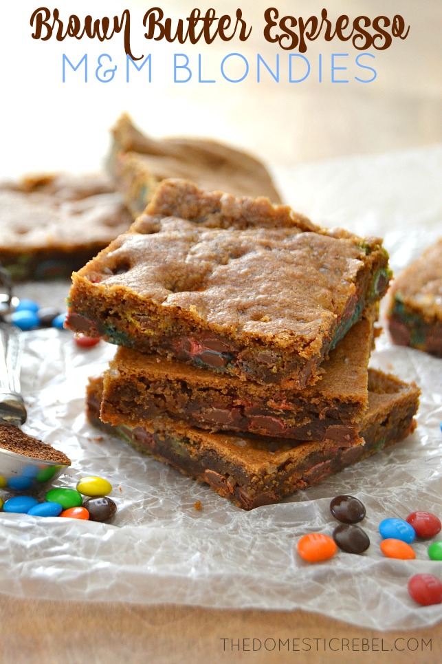 Brown Butter Espresso M&M Blondies stacked on parchment with mini M&Ms