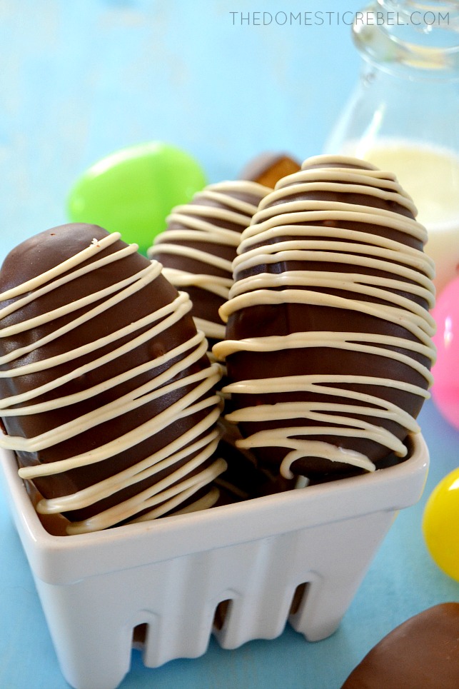 Reese's Brownie Bombs arranged in white basket with plastic eggs and milk in background