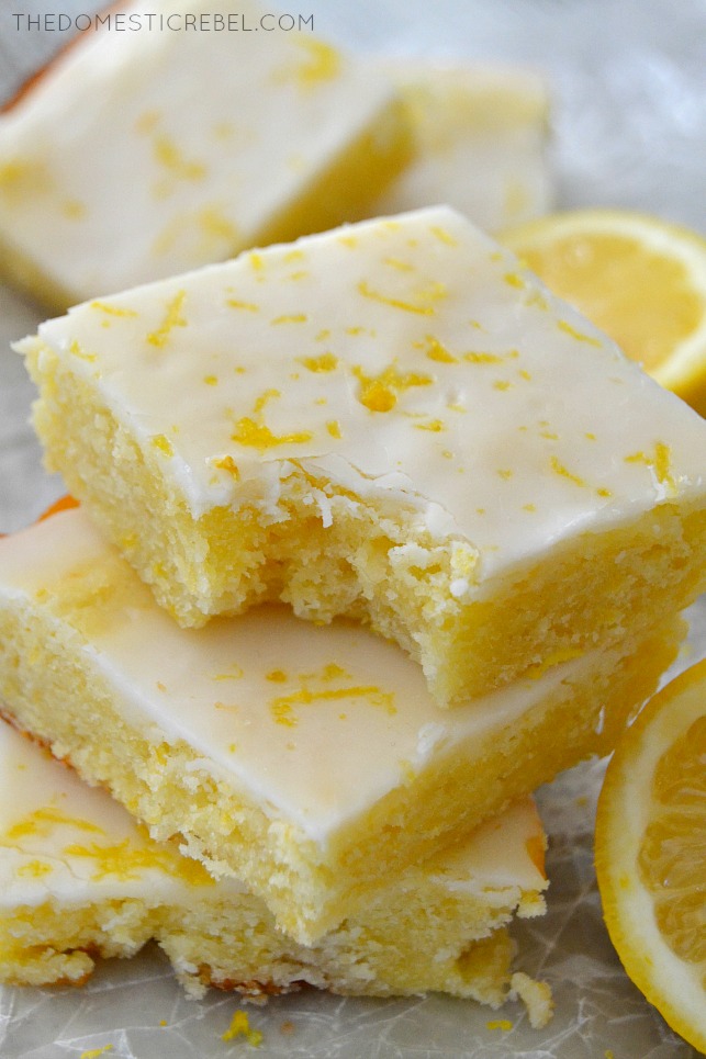 Fudgy Lemon Brownies stacked with bite removed and lemon slices
