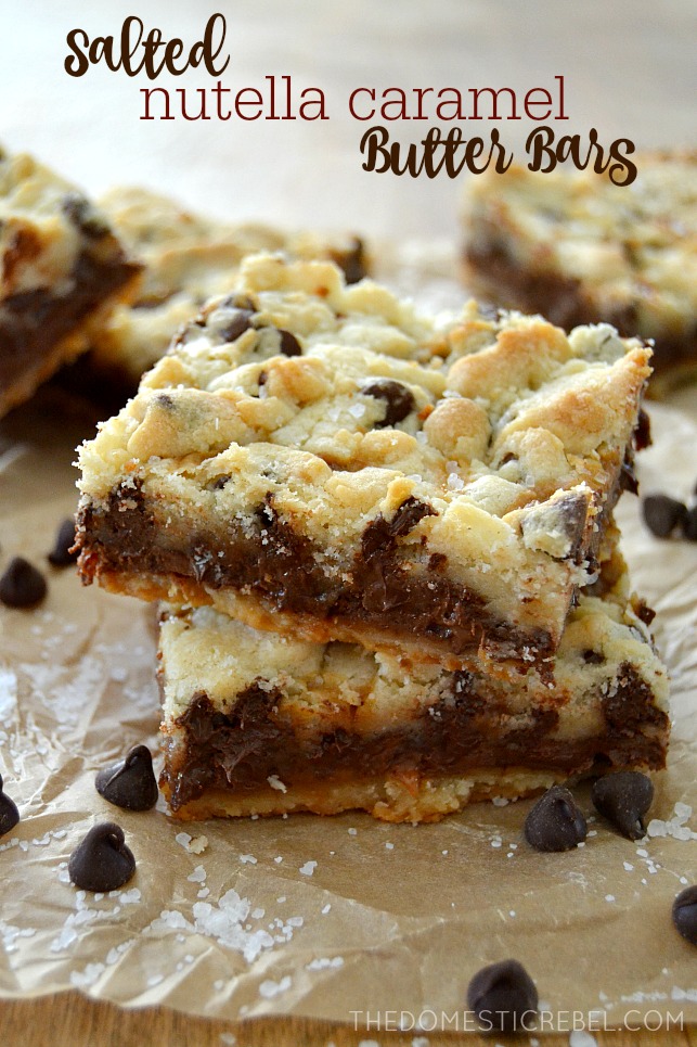 Salted Nutella Caramel Butter Bars stacked on parchment with chocolate chips
