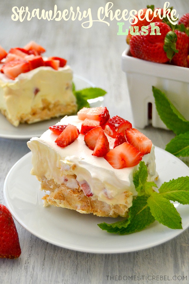 strawberry cheesecake lush dessert on white plates with mint and fresh strawberries
