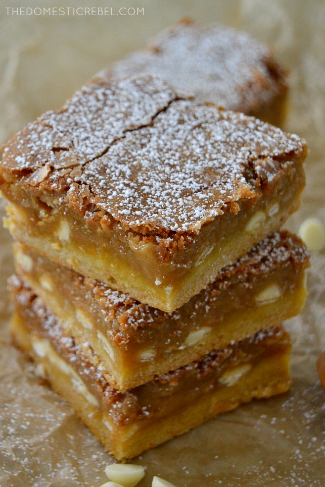 Biscoff White Chocolate Gooey Bars stacked on parchment