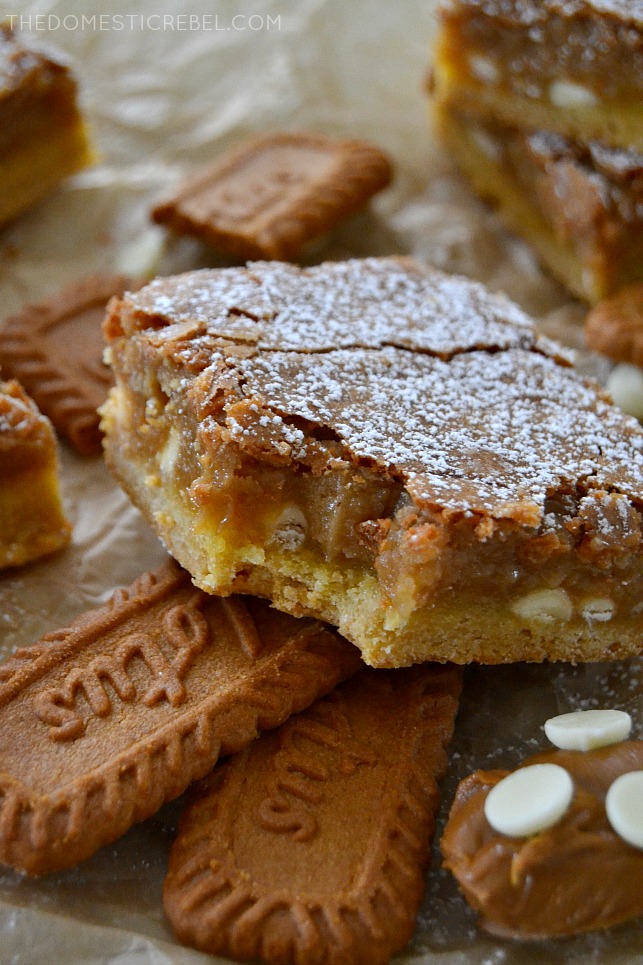 Biscoff White Chocolate Gooey Bar arranged with bite missing on cookies with white chips