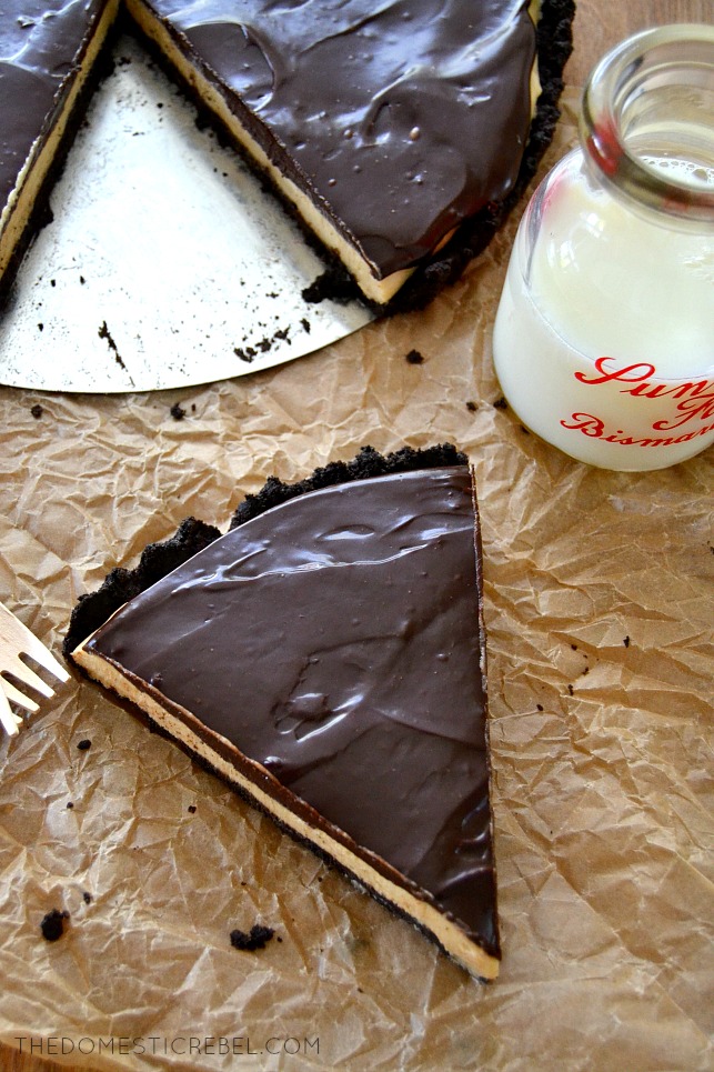 Chocolate PB Tart slice on parchment with pie pan and milk glass