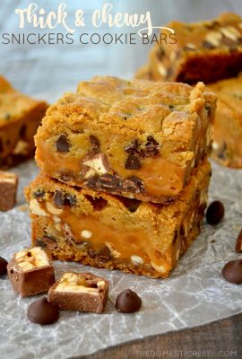 These Thick & Chewy Snickers Cookie Bars have only 6 simple ingredients and are SO EASY to make! Gooey, buttery, chocolaty and packed with flavor, they'll be your new way to eat a Snickers!