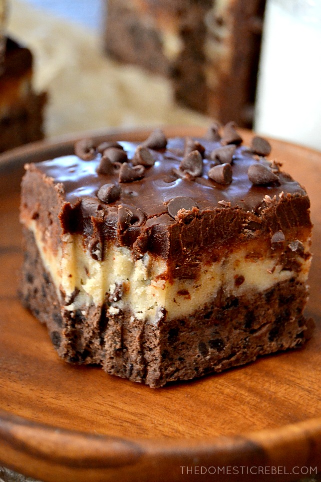 Cookie Dough Brownies with bite missing on wood plate