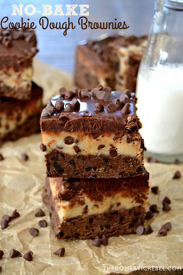 Cookie Dough Brownies stacked on parchment with choco chips and milk