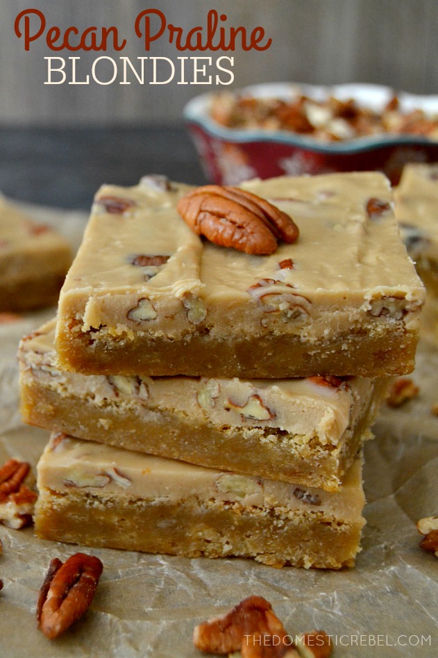 Pecan Praline Blondies stacked on parchment with pecans