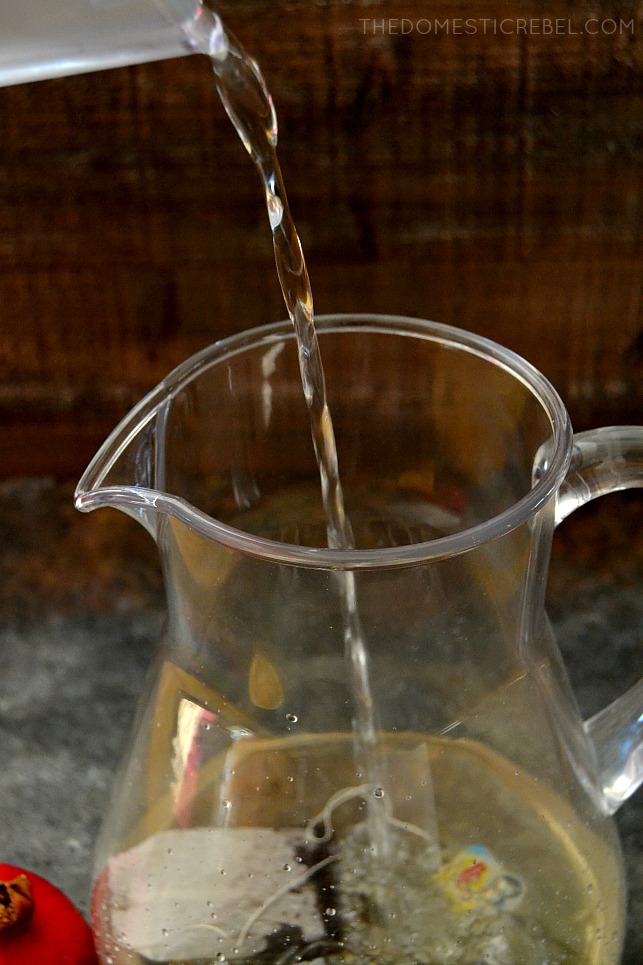 Water being poured into pitcher with tea