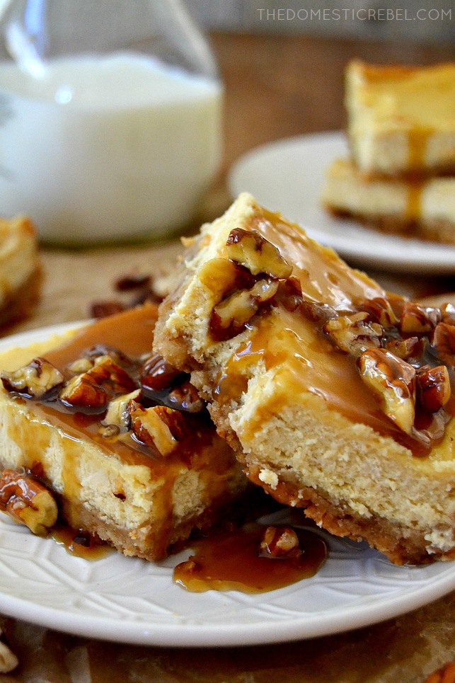 pecan praline cheesecake bars with bite missing on white plate with milk in background