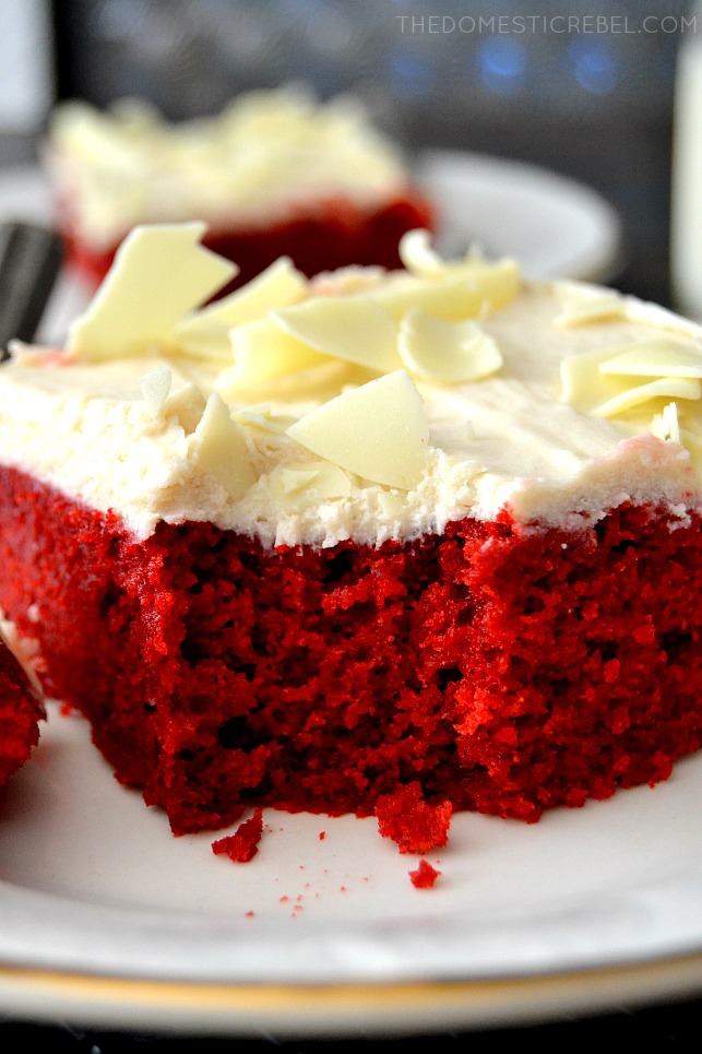 red velvet cake slice on white plate with bite missing