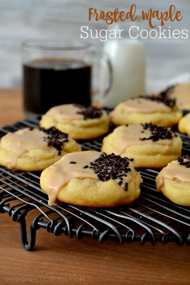 frosted maple sugar cookies arranged on black wire rack with coffee in background