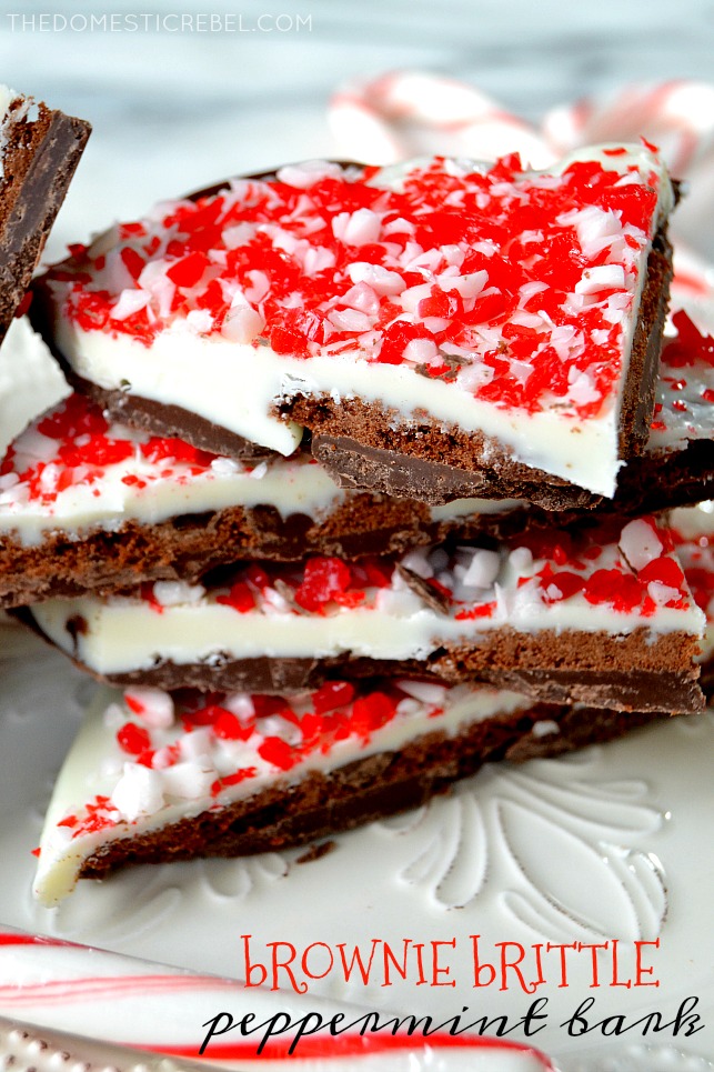 brownie brittle peppermint bark stacked on white plate with candy cane