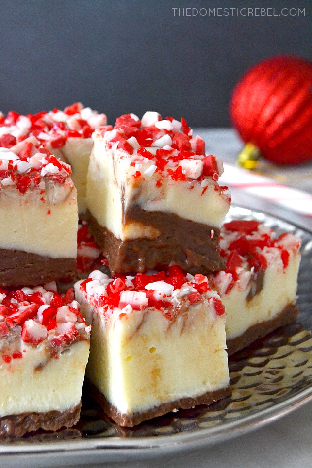 peppermint bark fudge stacked on silver plate with a red ornament