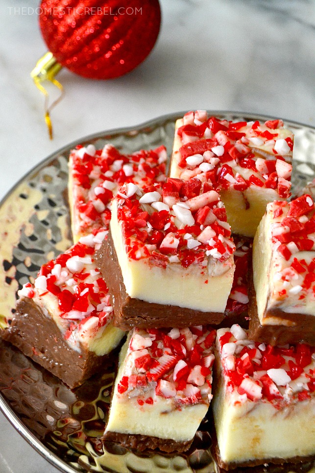 peppermint bark fudge arranged on silver plate with a red ornament in background