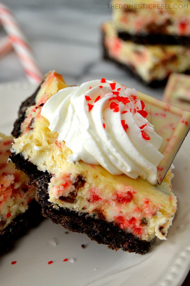 peppermint bark cheesecake bar with bite missing on white plate