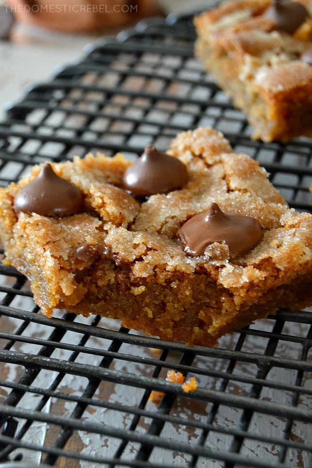 Blondie bar on a cooling rack with a bite missing.