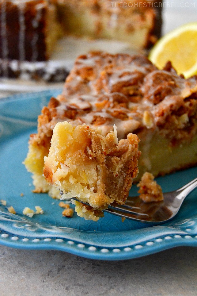 A BITE OF THE LEMON ALMOND CRUMB CAKE ON A FORK.