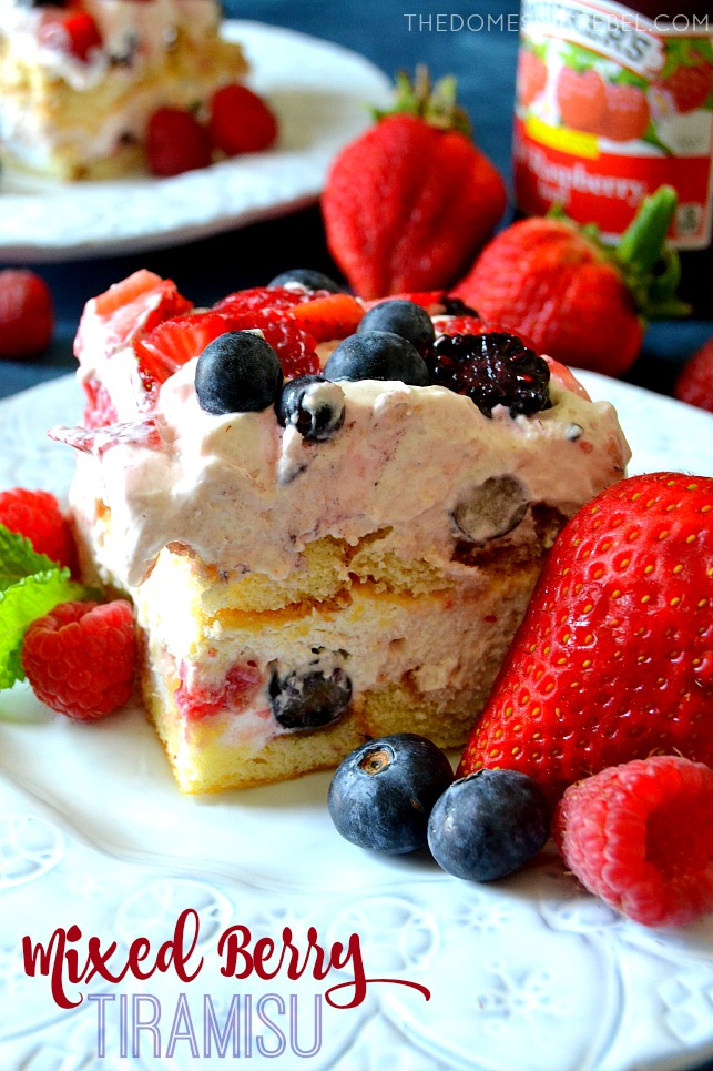 SLICE OF MIXED BERRY TIRAMISU ON A PLATE WITH BERRIES